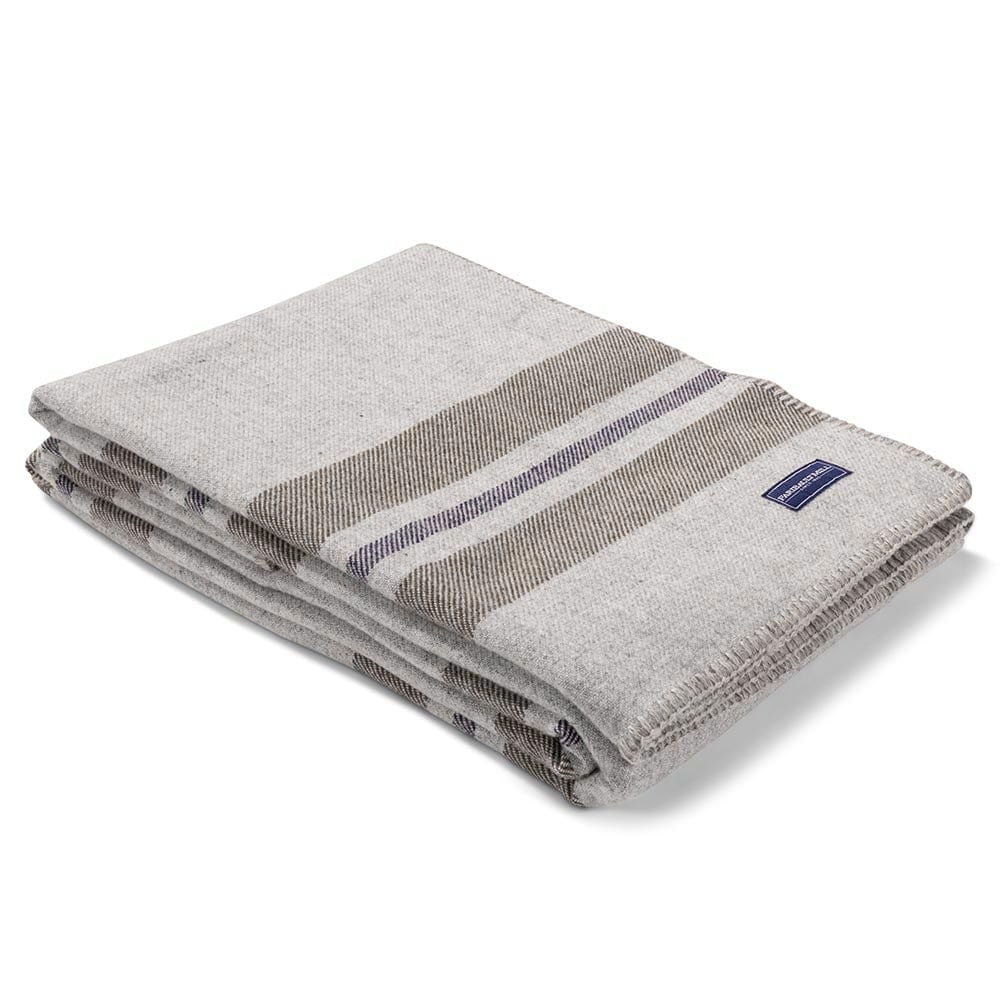 Faribault Mill Cabin smoke middleweight wool bed blanket, folded and displayed at an angle to highlight the thickness, loft of the wool, and whipstitched edges.
