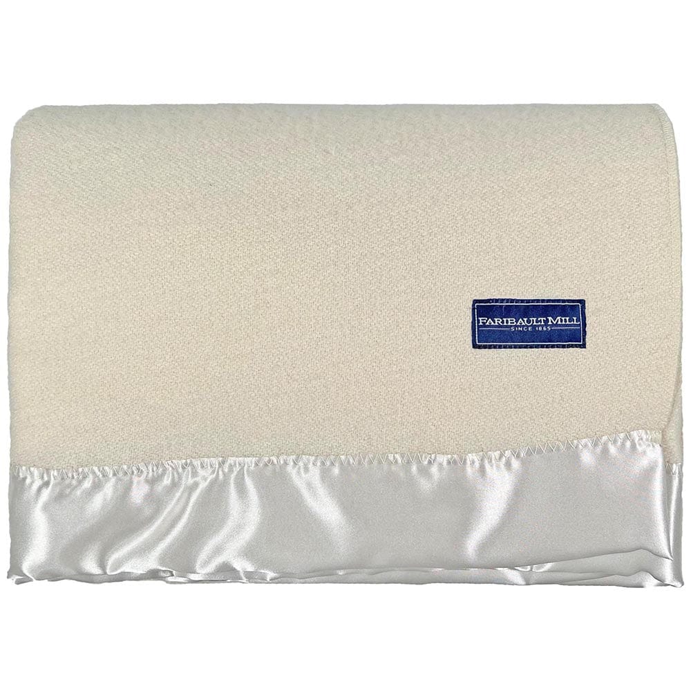 Faribault Mill Pure and Simple Satin bone white middleweight wool bed blanket, folded and displayed in a top-down view.