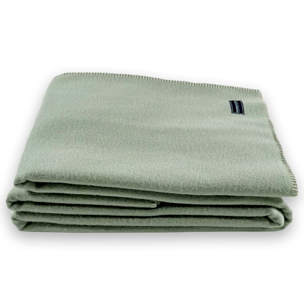 Faribault Mill Pure and Simple sea glass middleweight wool bed blanket, folded and displayed from the side to show the stacked layers and thickness.