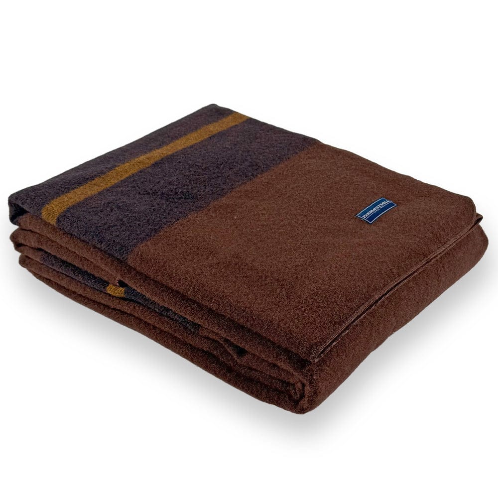 Faribault Mill Scout brown middleweight wool bed blanket, folded and displayed at an angle to highlight the thickness, loft of the wool, and serged edges.