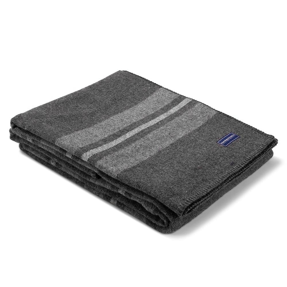 Faribault Mill Cabin charcoal middleweight wool bed blanket, folded and displayed at an angle to highlight the thickness, loft of the wool, and whipstitched edges.