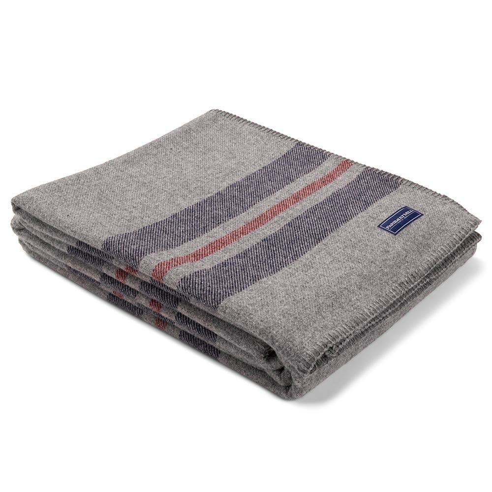 Faribault Mill Cabin heather gray middleweight wool bed blanket, folded and displayed at an angle to highlight the thickness, loft of the wool, and whipstitched edges.