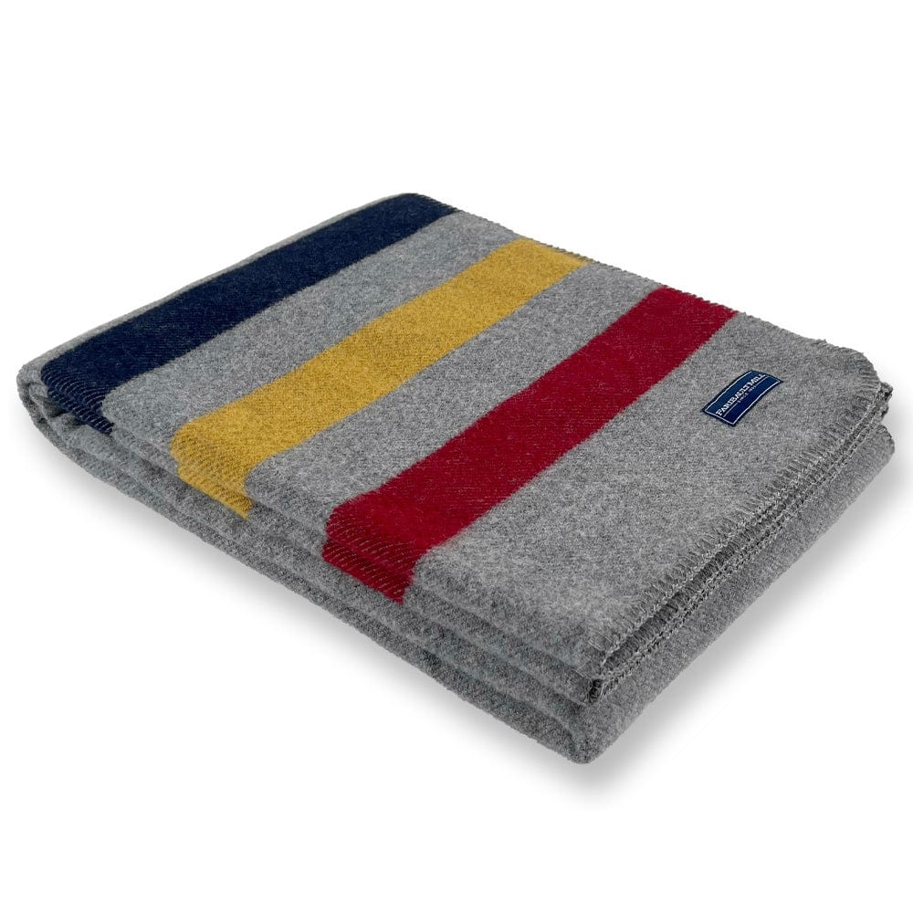 Faribault Mill Frontier gray middleweight wool throw, folded and displayed at an angle to highlight the thickness, loft of the wool, and whipstitched edges.