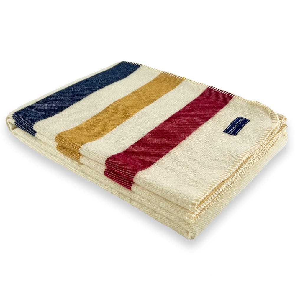 Faribault Mill Frontier natural middleweight wool throw, folded and displayed at an angle to highlight the thickness, loft of the wool, and whipstitched edges.