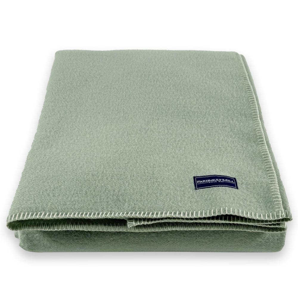 Faribault Mill Pure and Simple sea glass middleweight wool bed blanket, folded and displayed from the front showing the weave and texture.