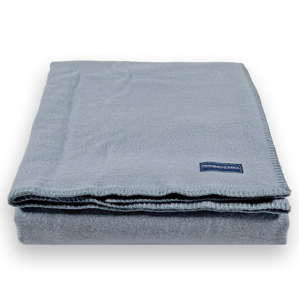 Faribault Mill Pure and Simple sky blue middleweight wool bed blanket, folded and displayed from the front showing the weave and texture.