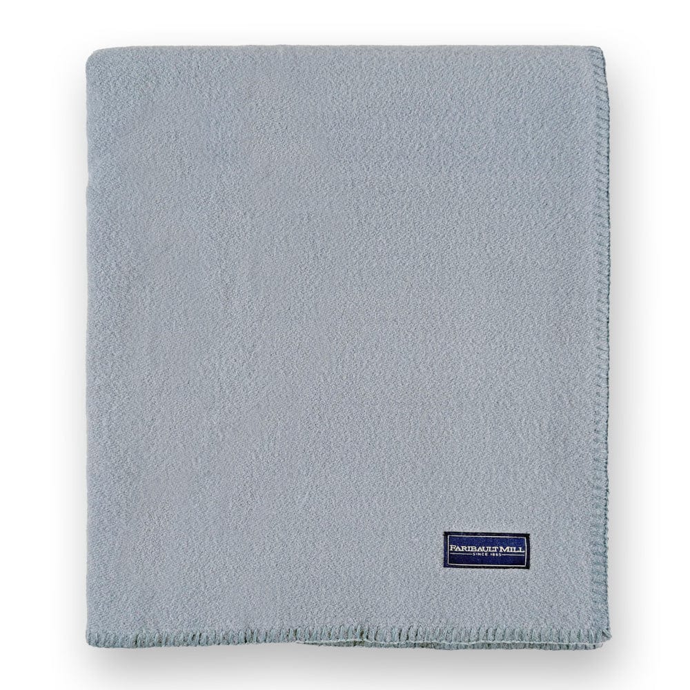 Faribault Mill Pure and Simple sky blue middleweight wool bed blanket, folded and displayed in a top-down view.