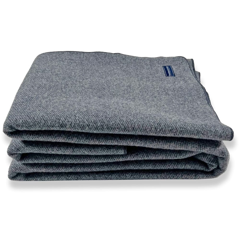 Faribault Mill Summit navy heavyweight wool bed blanket, folded and displayed from the side to show the stacked layers and thickness.