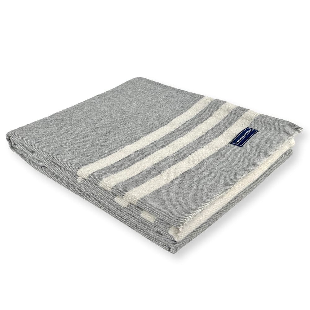 Faribault Mill Trapper gray lightweight wool throw, folded and displayed at an angle to highlight the thickness, loft of the wool, and leno edges.