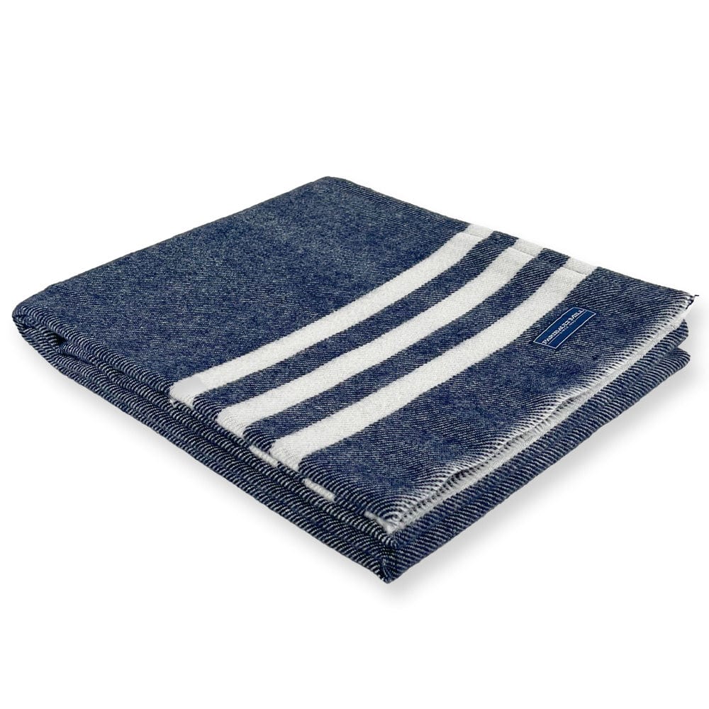 Faribault Mill Trapper navy lightweight wool throw, folded and displayed at an angle to highlight the thickness, loft of the wool, and leno edges.